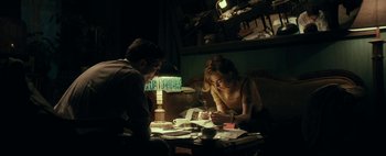 Movie still from “Mr. Jones” (2019), directed by Agnieszka Holland – A man and a woman sitting in front of a lamp; Medium shot, Over the shoulder angle