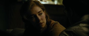 Movie still from “Mr. Jones” (2019), directed by Agnieszka Holland – A woman sitting in a chair with her eyes closed; Close Up shot, Over the shoulder angle
