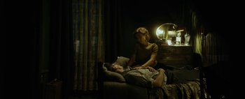 Movie still from “Mr. Jones” (2019), directed by Agnieszka Holland – A man and a woman laying on a bed; Wide shot, High angle