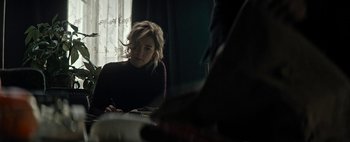 Movie still from “Mr. Jones” (2019), directed by Agnieszka Holland – A woman sitting at a table writing on a piece of paper; Medium shot, Over the shoulder angle