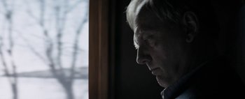 Movie still from “Mr. Jones” (2019), directed by Agnieszka Holland – An older man looking out of a window at night; Close Up shot, Low angle