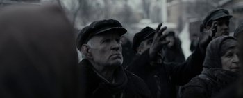 Movie still from “Mr. Jones” (2019), directed by Agnieszka Holland – A group of men in black hats and coats; Close Up shot, Over the shoulder angle