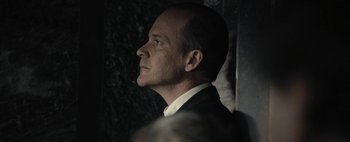 Movie still from “Mr. Jones” (2019), directed by Agnieszka Holland – A person wearing a suit and tie; Close Up shot, Low angle