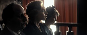 Movie still from “Mr. Jones” (2019), directed by Agnieszka Holland – Two women are standing side - by - side in front of a window; Close Up shot, Low angle