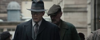 Movie still from “Mr. Jones” (2019), directed by Agnieszka Holland – A man in a suit and a man in a hat; Medium shot, Over the shoulder angle