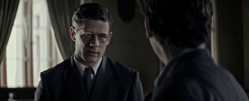 Movie still from “Mr. Jones” (2019), directed by Agnieszka Holland – A man in a suit and tie talking to another man in a suit and tie; Close Up shot, Over the shoulder angle