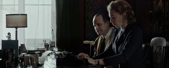 Movie still from “Mr. Jones” (2019), directed by Agnieszka Holland – A man and a woman are typing on a typewriter; Medium shot, High angle