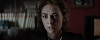 Movie still from “Mr. Jones” (2019), directed by Agnieszka Holland – A person looking at the camera; Close Up shot, Over the shoulder angle