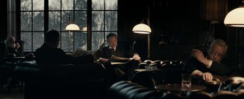 Movie still from “Mr. Jones” (2019), directed by Agnieszka Holland – A man sitting in a chair reading a newspaper; Medium shot, Low angle