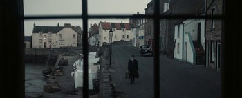 Movie still from “Mr. Jones” (2019), directed by Agnieszka Holland – A man walking down the street holding a briefcase; Wide shot, High angle