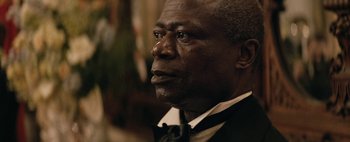 Movie still from “Mr. Jones” (2019), directed by Agnieszka Holland – An older man wearing a suit and a tie; Close Up shot, Over the shoulder angle
