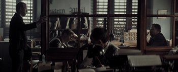 Movie still from “Mr. Jones” (2019), directed by Agnieszka Holland – Two men sitting at a table in front of a window; Medium shot, Over the shoulder angle