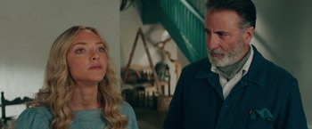 Movie still from “Mamma Mia! Here We Go Again” (2018), directed by Ol Parker – A man and a woman standing next to each other in a room; Close Up shot, Over the shoulder angle
