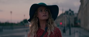 Movie still from “Mamma Mia! Here We Go Again” (2018), directed by Ol Parker – A woman wearing a blue hat and a red sweater; Close Up shot, Low angle