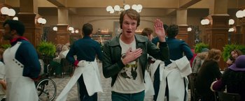 Movie still from “Mamma Mia! Here We Go Again” (2018), directed by Ol Parker – A man in a white shirt and a black leather jacket; Medium shot, Over the shoulder angle