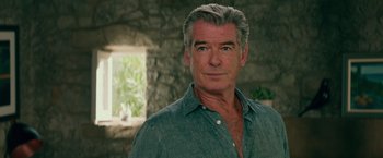 Movie still from “Mamma Mia! Here We Go Again” (2018), directed by Ol Parker – Pierce brosnan wearing a green shirt; Close Up shot, Over the shoulder angle