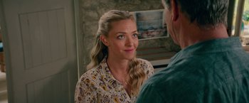 Movie still from “Mamma Mia! Here We Go Again” (2018), directed by Ol Parker – A woman in a yellow and white floral shirt is looking at a man in a blue shirt; Close Up shot, Over the shoulder angle