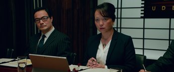 Movie still from “Mamma Mia! Here We Go Again” (2018), directed by Ol Parker – A woman sitting at a table in front of an open laptop computer; Close Up shot, Over the shoulder angle