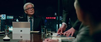 Movie still from “Mamma Mia! Here We Go Again” (2018), directed by Ol Parker – A man sitting at a table in front of another man; Medium shot, Over the shoulder angle