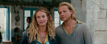 Movie still from “Mamma Mia! Here We Go Again” (2018), directed by Ol Parker – A man and a woman standing next to each other; Close Up shot, Low angle