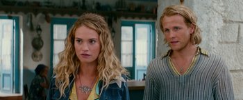 Movie still from “Mamma Mia! Here We Go Again” (2018), directed by Ol Parker – A woman and a man standing next to each other in a room; Close Up shot, Over the shoulder angle