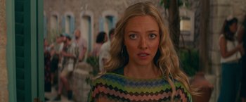 Movie still from “Mamma Mia! Here We Go Again” (2018), directed by Ol Parker – A person with long blonde hair; Close Up shot, Over the shoulder angle