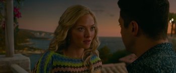 Movie still from “Mamma Mia! Here We Go Again” (2018), directed by Ol Parker – A beautiful young woman wearing a multicolored dress; Close Up shot, Over the shoulder angle