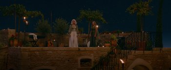 Movie still from “Mamma Mia! Here We Go Again” (2018), directed by Ol Parker – A couple of women standing next to each other on top of stairs; Wide shot, High angle
