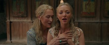 Movie still from “Mamma Mia! Here We Go Again” (2018), directed by Ol Parker – Two women standing next to each other in front of a wall; Close Up shot, Over the shoulder angle