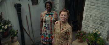 Movie still from “Mrs. Harris Goes to Paris” (2022), directed by Anthony Fabian – Two older women standing next to each other; Medium shot, High angle