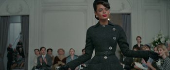 Movie still from “Mrs. Harris Goes to Paris” (2022), directed by Anthony Fabian – A woman in a black coat is holding a cane; Medium shot, Low angle