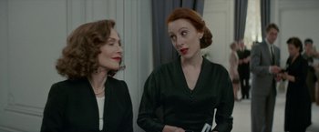 Movie still from “Mrs. Harris Goes to Paris” (2022), directed by Anthony Fabian – Two women are talking to each other in a room; Medium shot, Over the shoulder angle