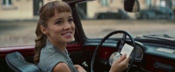 Movie still from “Mrs. Harris Goes to Paris” (2022), directed by Anthony Fabian – A woman sitting in the driver's seat of a car; Close Up shot, Over the shoulder angle