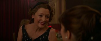 Movie still from “Mrs. Harris Goes to Paris” (2022), directed by Anthony Fabian – An older woman wearing a black and white polka dot dress; Close Up shot, Over the shoulder angle