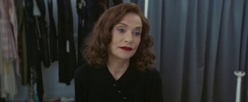 Movie still from “Mrs. Harris Goes to Paris” (2022), directed by Anthony Fabian – A person wearing a black shirt; Close Up shot, Over the shoulder angle