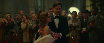 Movie still from “Mrs. Harris Goes to Paris” (2022), directed by Anthony Fabian – A man and a woman in formal wear dancing; Medium shot, Low angle