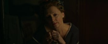 Movie still from “Mrs. Harris Goes to Paris” (2022), directed by Anthony Fabian – An older woman is holding a pair of scissors in her hands; Close Up shot, High angle