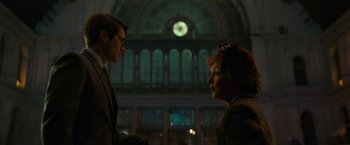 Movie still from “Mrs. Harris Goes to Paris” (2022), directed by Anthony Fabian – A man and a woman talking in front of a building; Medium shot, Low angle