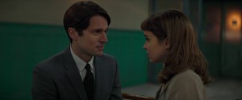 Movie still from “Mrs. Harris Goes to Paris” (2022), directed by Anthony Fabian – A man and a woman are looking at one another; Close Up shot, Over the shoulder angle