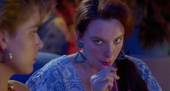 Movie still from “Muriel's Wedding” (1994), directed by P.J. Hogan – A woman is holding a pencil in her mouth; Close Up shot, Over the shoulder angle