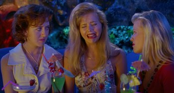 Movie still from “Muriel's Wedding” (1994), directed by P.J. Hogan – A group of people standing next to each other at a party; Close Up shot, High angle