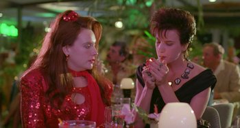 Movie still from “Muriel's Wedding” (1994), directed by P.J. Hogan – Two women are sitting at a dinner table; Close Up shot, Low angle