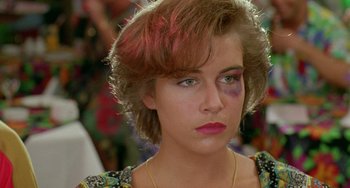 Movie still from “Muriel's Wedding” (1994), directed by P.J. Hogan – A young woman with a bruised eye is looking at the camera; Close Up shot, Over the shoulder angle