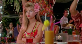Movie still from “Muriel's Wedding” (1994), directed by P.J. Hogan – A woman sitting at a table with a drink in front of her; Close Up shot, Over the shoulder angle