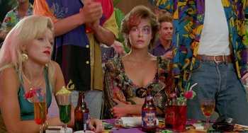 Movie still from “Muriel's Wedding” (1994), directed by P.J. Hogan – A woman sitting at a table with drinks; Medium shot, Over the shoulder angle