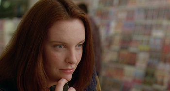 Movie still from “Muriel's Wedding” (1994), directed by P.J. Hogan – A person holding a cell phone; Close Up shot, Over the shoulder angle