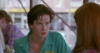 Movie still from “Muriel's Wedding” (1994), directed by P.J. Hogan – A person with short hair; Close Up shot, Over the shoulder angle