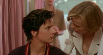 Movie still from “Muriel's Wedding” (1994), directed by P.J. Hogan – A woman looking at another woman in front of another woman; Close Up shot, Over the shoulder angle