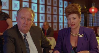 Movie still from “Muriel's Wedding” (1994), directed by P.J. Hogan – A man and a woman sitting at a dinner table; Close Up shot, Low angle