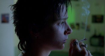 Movie still from “Muriel's Wedding” (1994), directed by P.J. Hogan – A person with a ring in their mouth; Close Up shot, Low angle